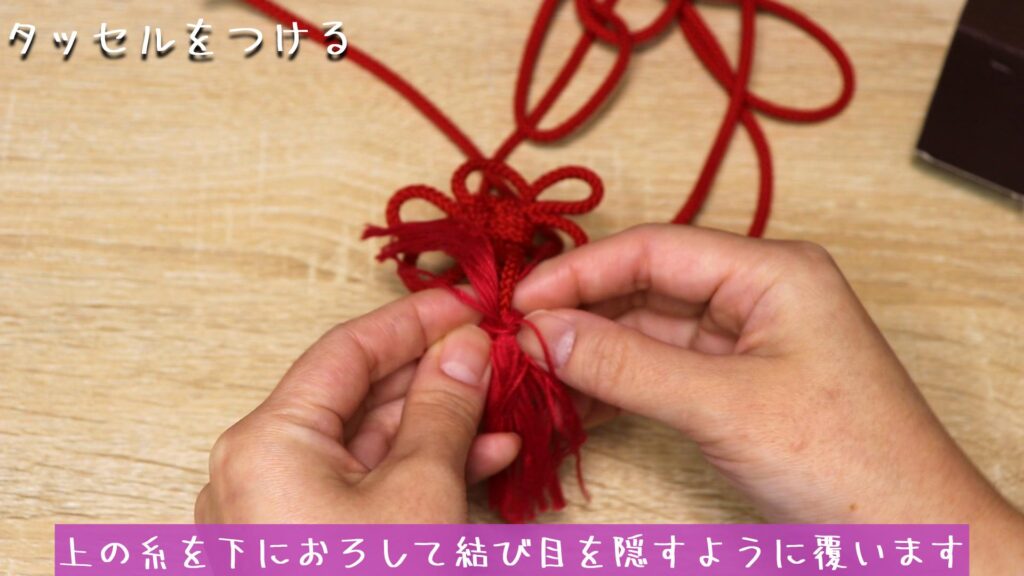 上の糸を下におろして結び目を隠すように覆います
